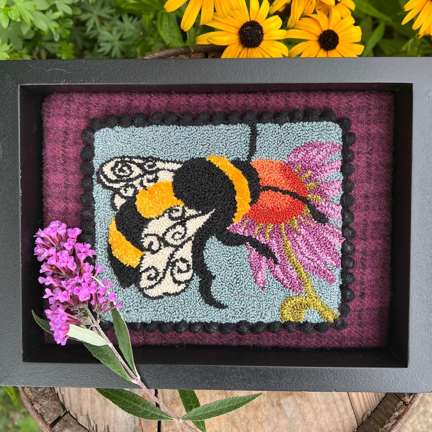 A Bee's Kiss- Needle Punch Pattern by Orphaned Wool, Copyright © 2023 Kelly Kanyok. This pattern is available as a Printed on Cloth pattern or Paper Pattern.  The design of a bee kissing a colorful flower.