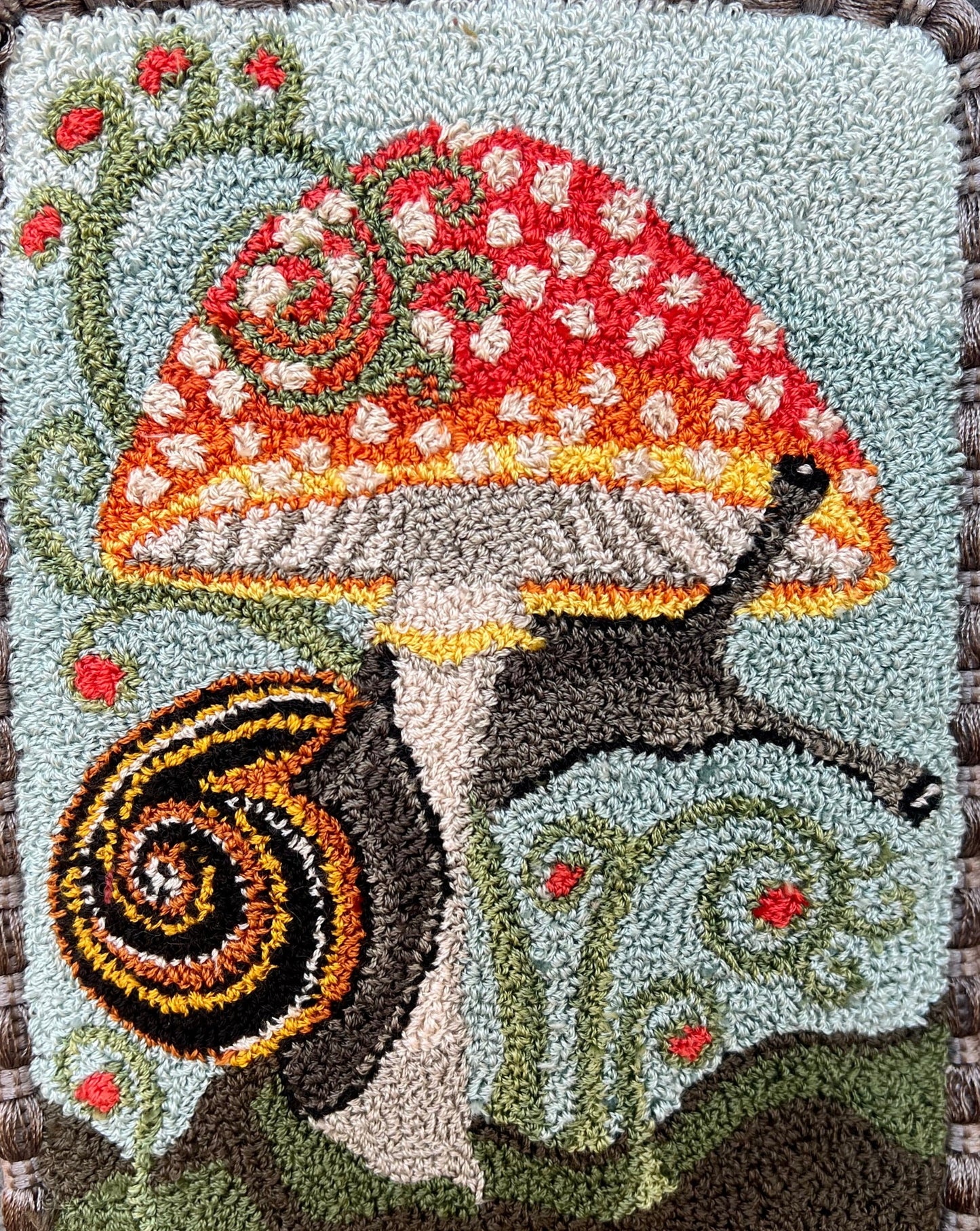  Presenting the enchanting "ENTWINED" Paper Rug Hooking Pattern by Orphaned Wool. This delightful design showcases a charming snail gracefully wrapping around a vibrant mushroom. This fabulous paper pattern offers you the opportunity to bring the wonders of nature to life and create the perfect size pattern you desire. The Entwined pattern is copyrighted 2024 Kelly Kanyok, Orphaned Wool.