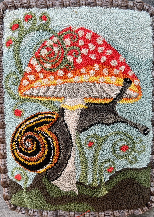  The Pattern Entwined is an PDF digial downloadable  punch Needle Embroidery pattern that used thread and a punch needle to create the design. Entwined design depicts a snail wrapping itself around a colorful mushroom. Copyright © 2024 Kelly Kanyok of Orphaned Wool.