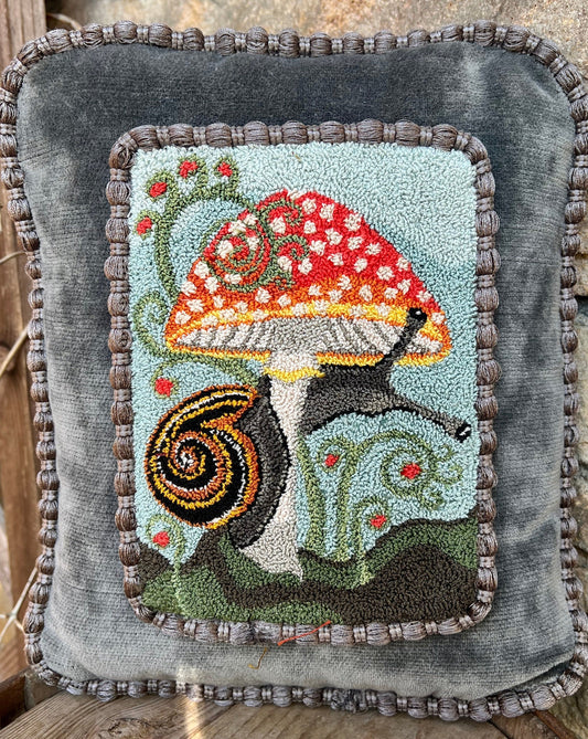  The Pattern Entwined is a punch Needle Embroidery pattern that used thread and a punch needle to create the design. Entwinted design depicts a snail wrapping itself around a colorful mushroom. Copyright © 2024 Kelly Kanyok of Orphaned Wool.