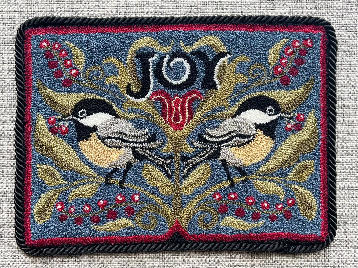 Chickadee Joy punch needle pattern featuring two chickadees and winter berries