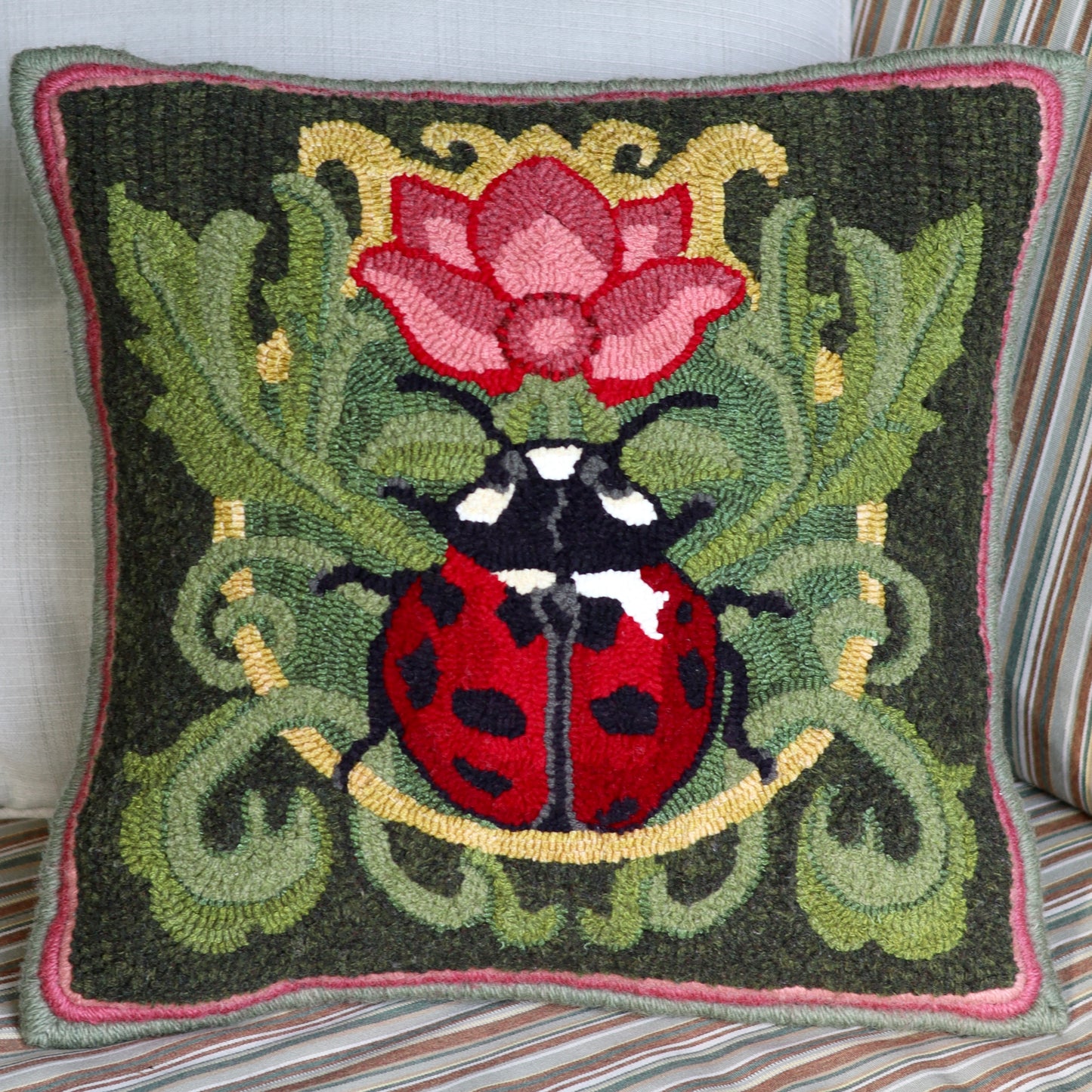 Decorative pillow featuring a ladybug with a flower Rug Hooking Pattern - By Orphaned Wool