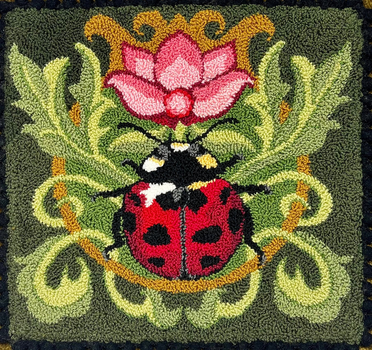 Ladybug pattern by Orphaned Wool, A colorful garden ladybug on leaves with a pink flower.