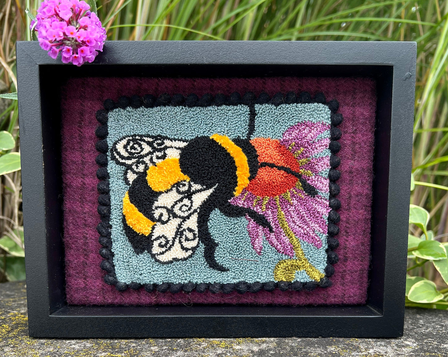 A Bee's Kiss - Needle Punch Pattern with custom Thread kit, by Orphaned Wool designed and Copyright © 2023 Kelly Kanyok. This is a delightful pattern of a bee visiting a flower.