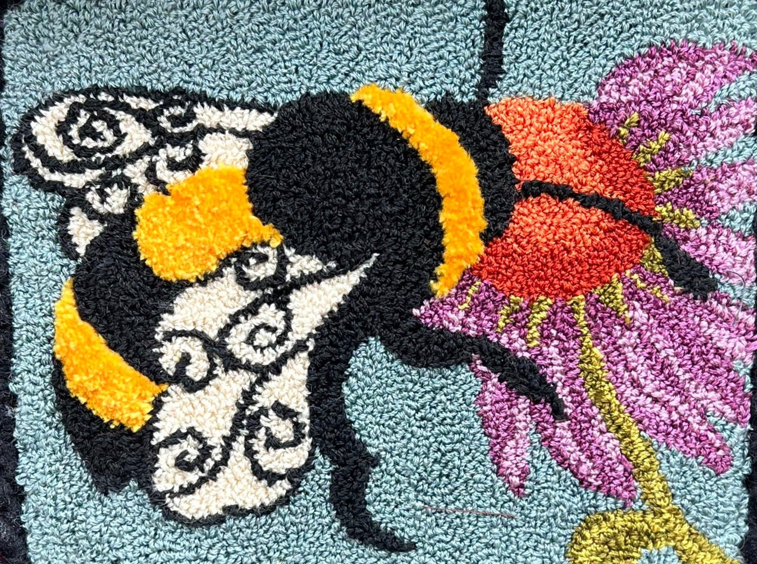  A Bee's Kiss- Paper Rug Hooking Pattern, by Orphaned Wool, Copyright © 2023 Kelly Kanyok. This is a beautifully designed pattern of a bumblebee feeding from a colorful flower. Paper patterns are designed for enlargement.