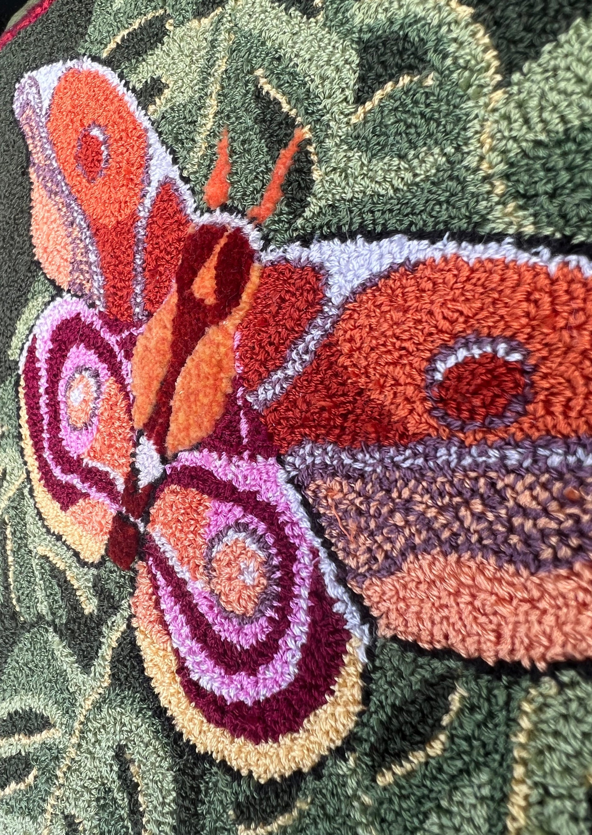 Bullseye Moth Paper Rug Hooking Pattern by Orphaned Wool, copyright © 2023 Kelly Kanyok. This pattern design is of a beautiful Bullseye Moth on top of a collection of leaves. Enjoy the stunning color inspired by nature herself.