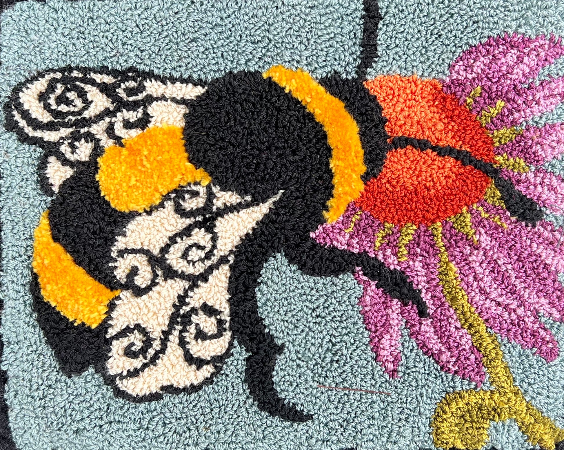  A Bee's Kiss- Paper Rug Hooking Pattern, by Orphaned Wool, Copyright © 2023 Kelly Kanyok. This is a beautifully designed pattern of a bumblebee feeding from a colorful flower. Paper patterns are designed for enlargement.