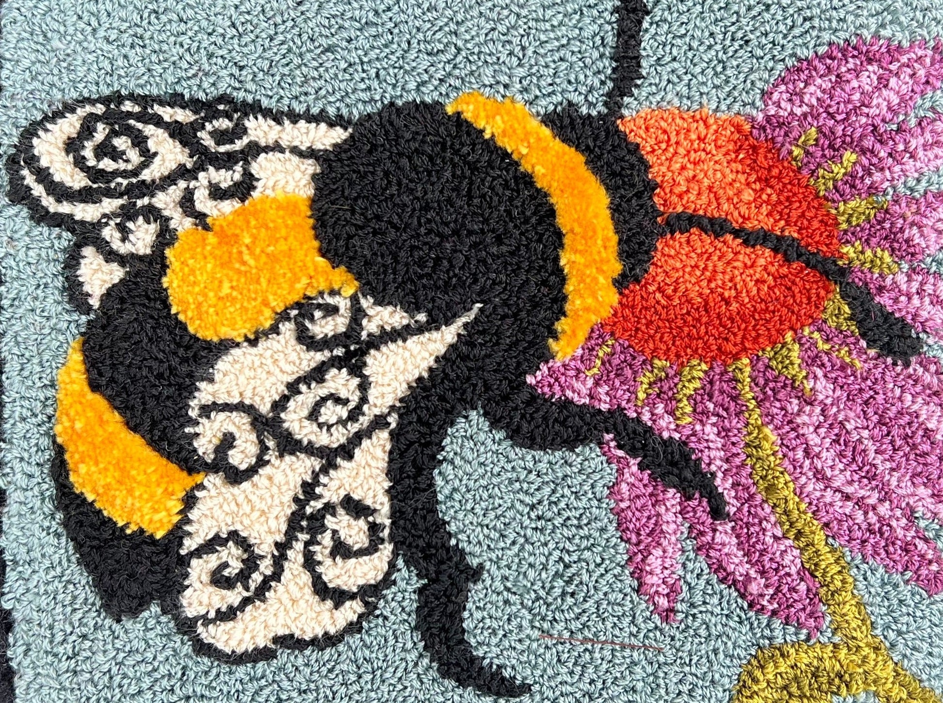  A Bee's Kiss- PDF Rug Hooking Digital Download Pattern by Orphaned Wool, Copyright © 2023 Kelly Kanyok. Create a incredible rug, wall hanging or pillow with this sweet bumblebee design of a bee feeding from a vibrantly colored flower.