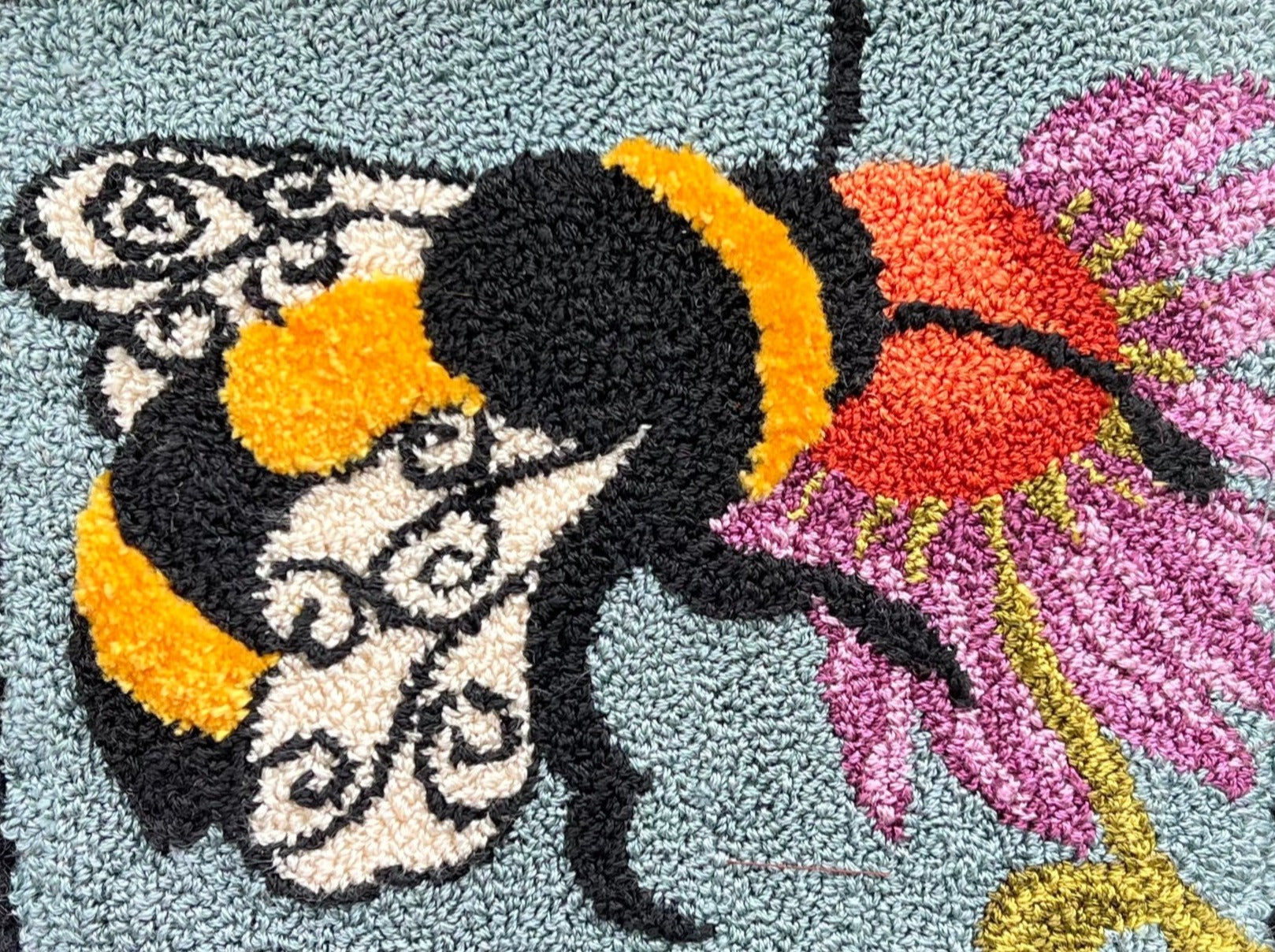  A Bee's Kiss- PDF Rug Hooking Digital Download Pattern by Orphaned Wool, Copyright © 2023 Kelly Kanyok. Create a incredible rug, wall hanging or pillow with this sweet bumblebee design of a bee feeding from a vibrantly colored flower.