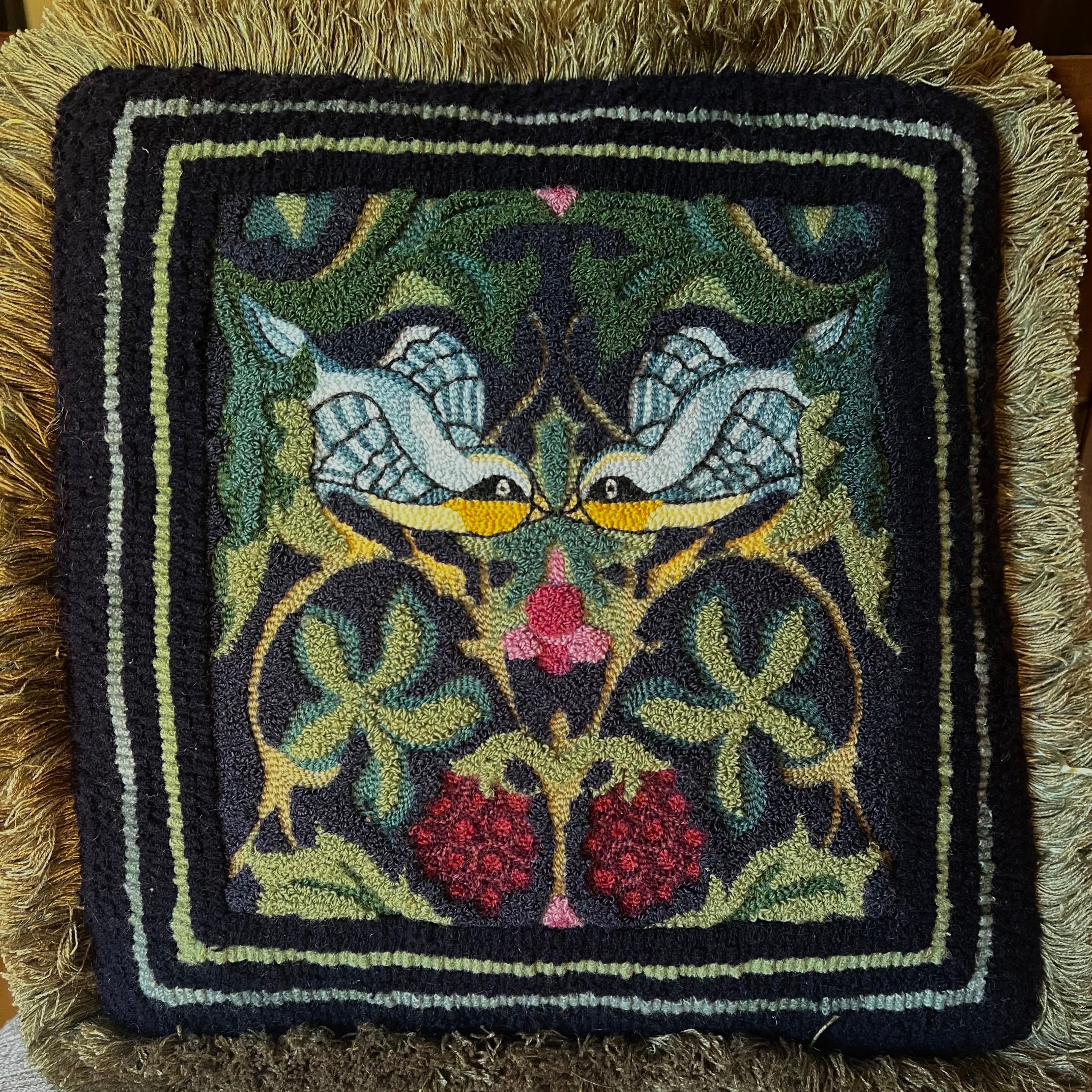 Whispering Wings is a punch needle PDF digital download file from Orphaned Wool, Copyright  2024 Kelly Kanyk. This design features two birds amongst the foliage and grapes, and includes directions to create this pattern as dimensional or normal punch needle pattern.