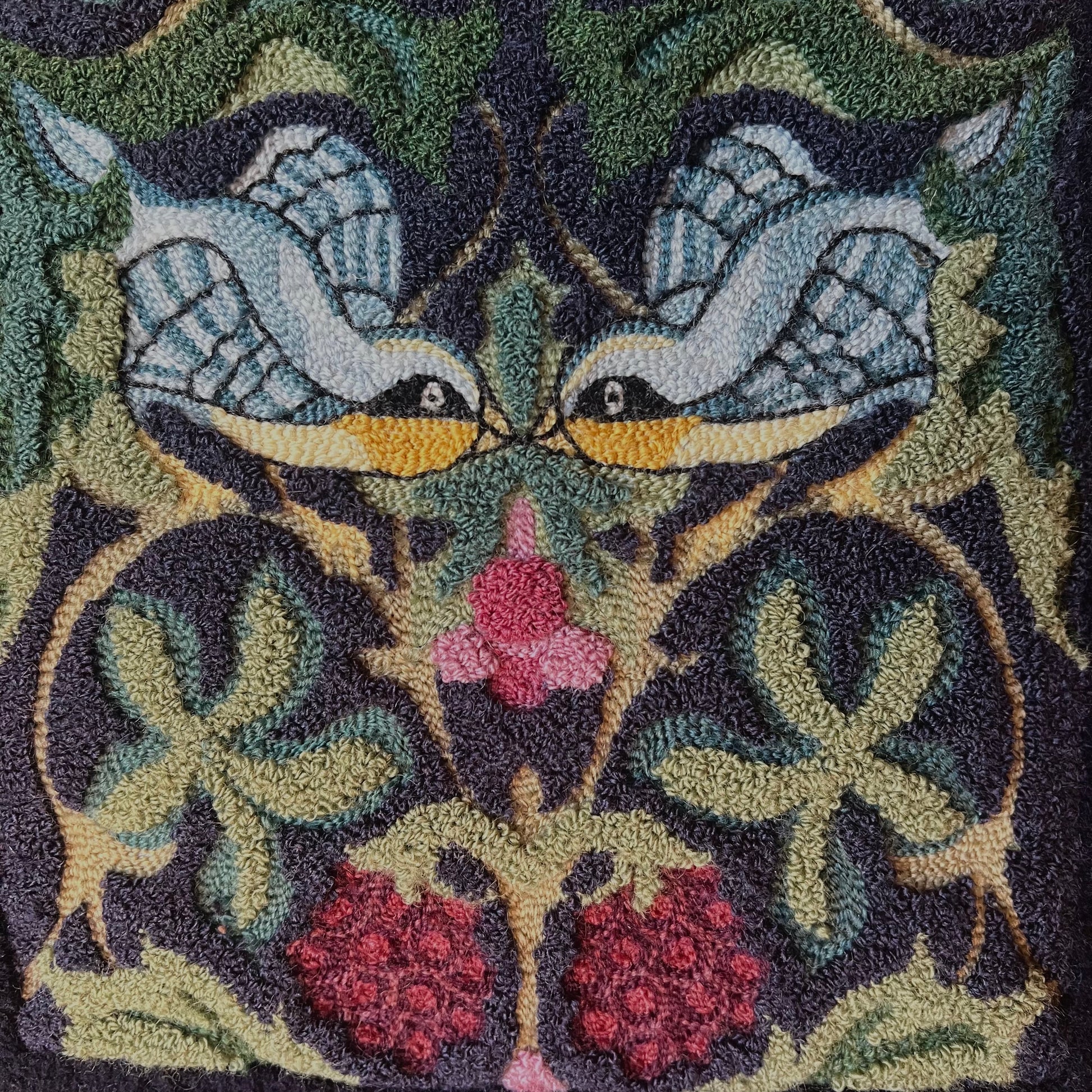 Whispering Wings is a punch needle PDF digital download file from Orphaned Wool, Copyright  2024 Kelly Kanyk. This design features two birds amongst the foliage and grapes, and includes directions to create this pattern as dimensional or normal punch needle pattern.