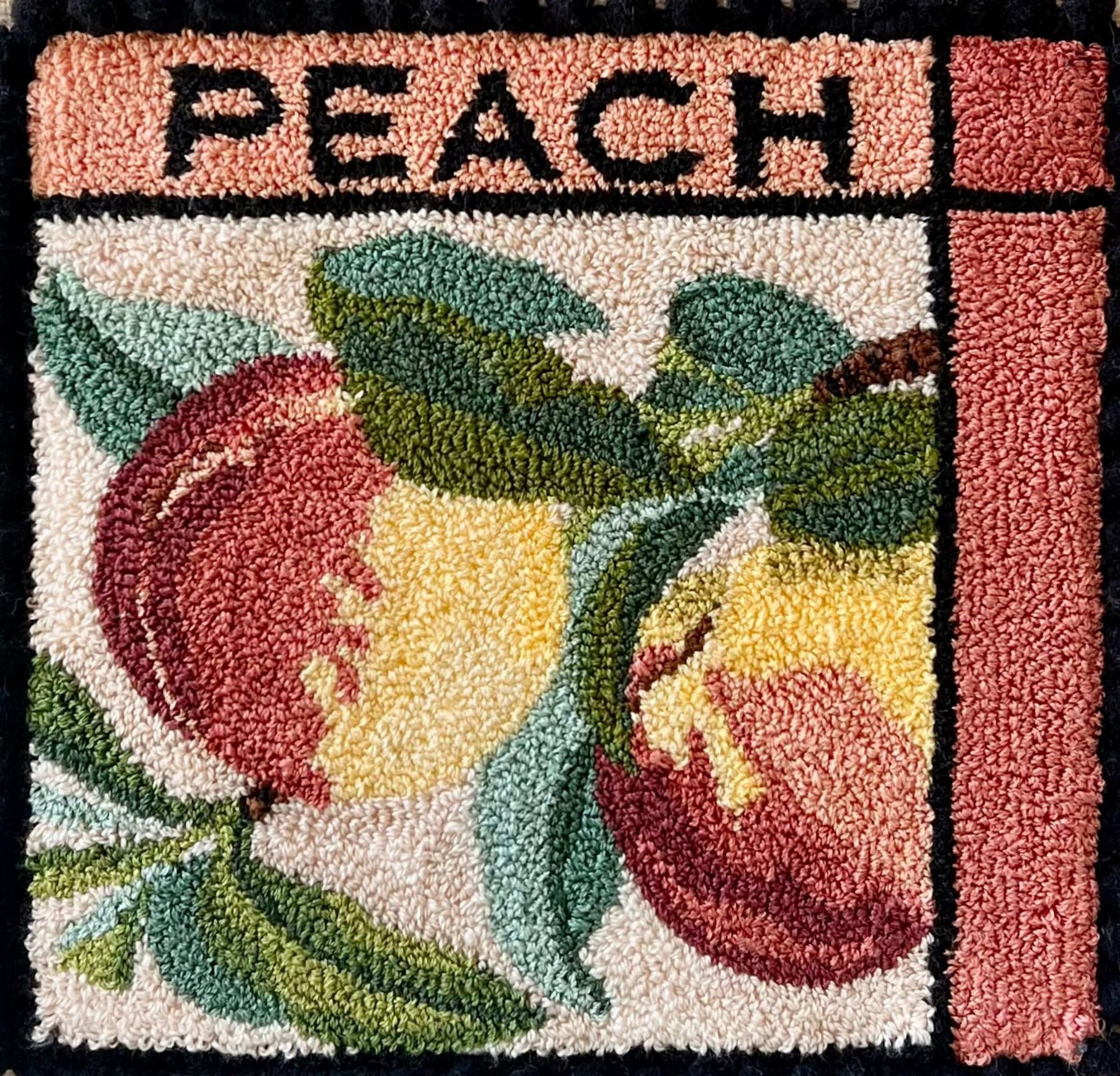 Peach- Punch Needle Pattern by Orphaned Wool, Copyright ©2025 Kelly Kanyok. Available in paper, cloth, printed patterns, or a set of four patterned designs (Fruit Series). Pattern features  two colorful peaches with the word PEACH at the top of the design.
