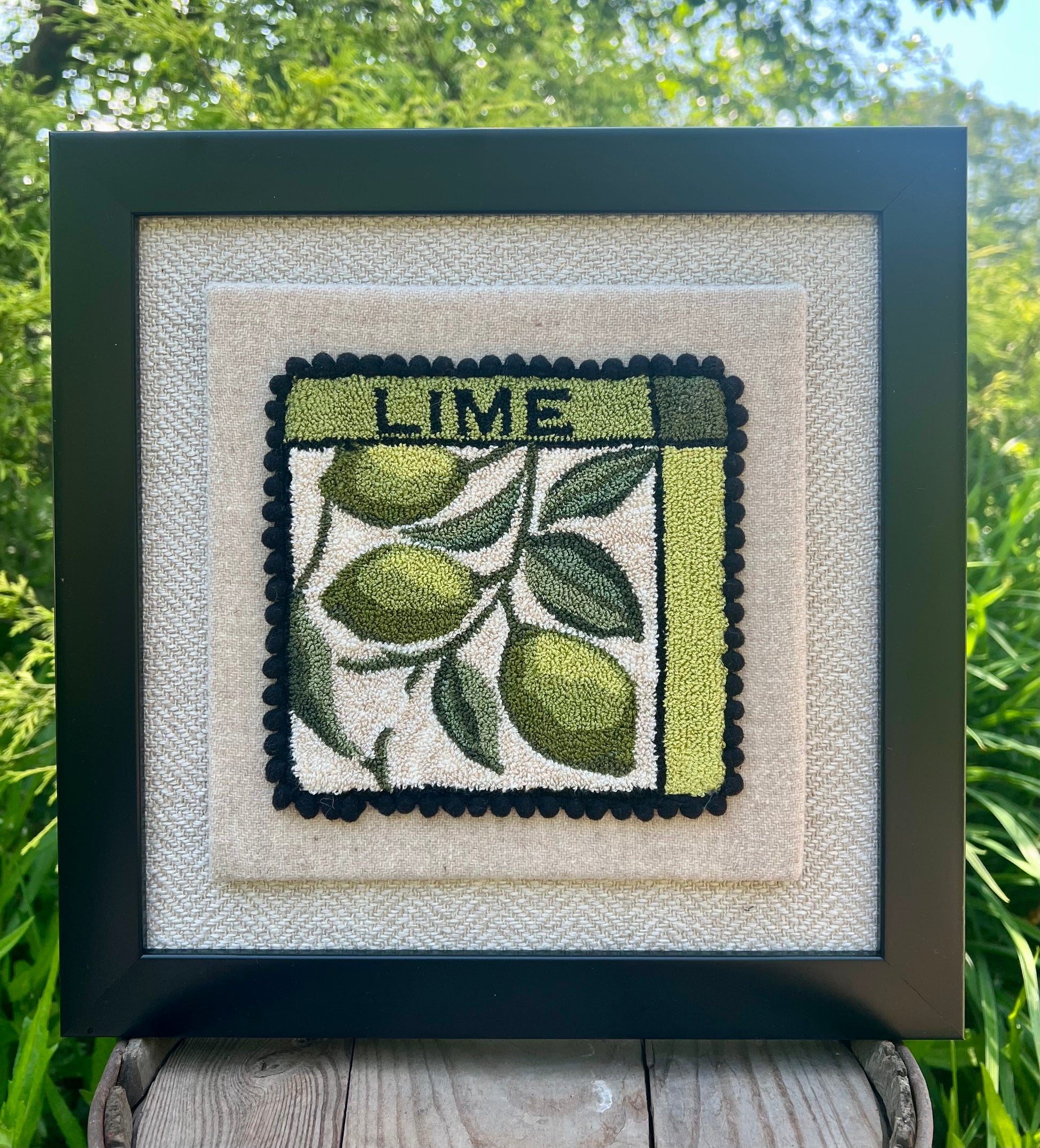 Lime Punch Needle Pattern, Paper or Printed on Cloth options, by Orphaned Wool, copyright 2025 Kelly Kanyok. Pattern features a series of three limes hanging from a vine with the word LIME at the top of the design.