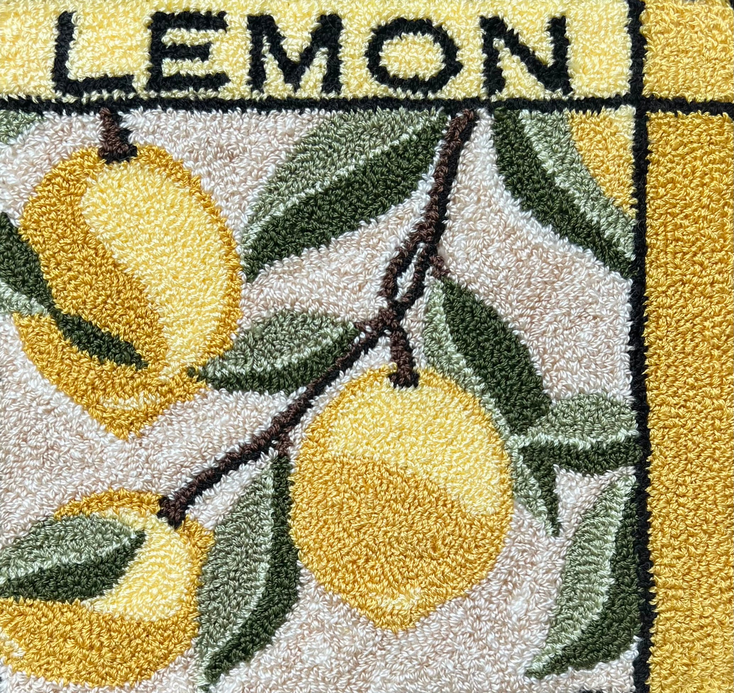 Lemon -Punch Needle Pattern, Paper, printed on cloth, or fruit series set option, by Orphaned Wool, Copyright 2025 Kelly Kanyok. This is a 5 1/2 x 5 1/2 punch needle pattern featuring three lemons on the vine with the word 'LEMON' at the top.