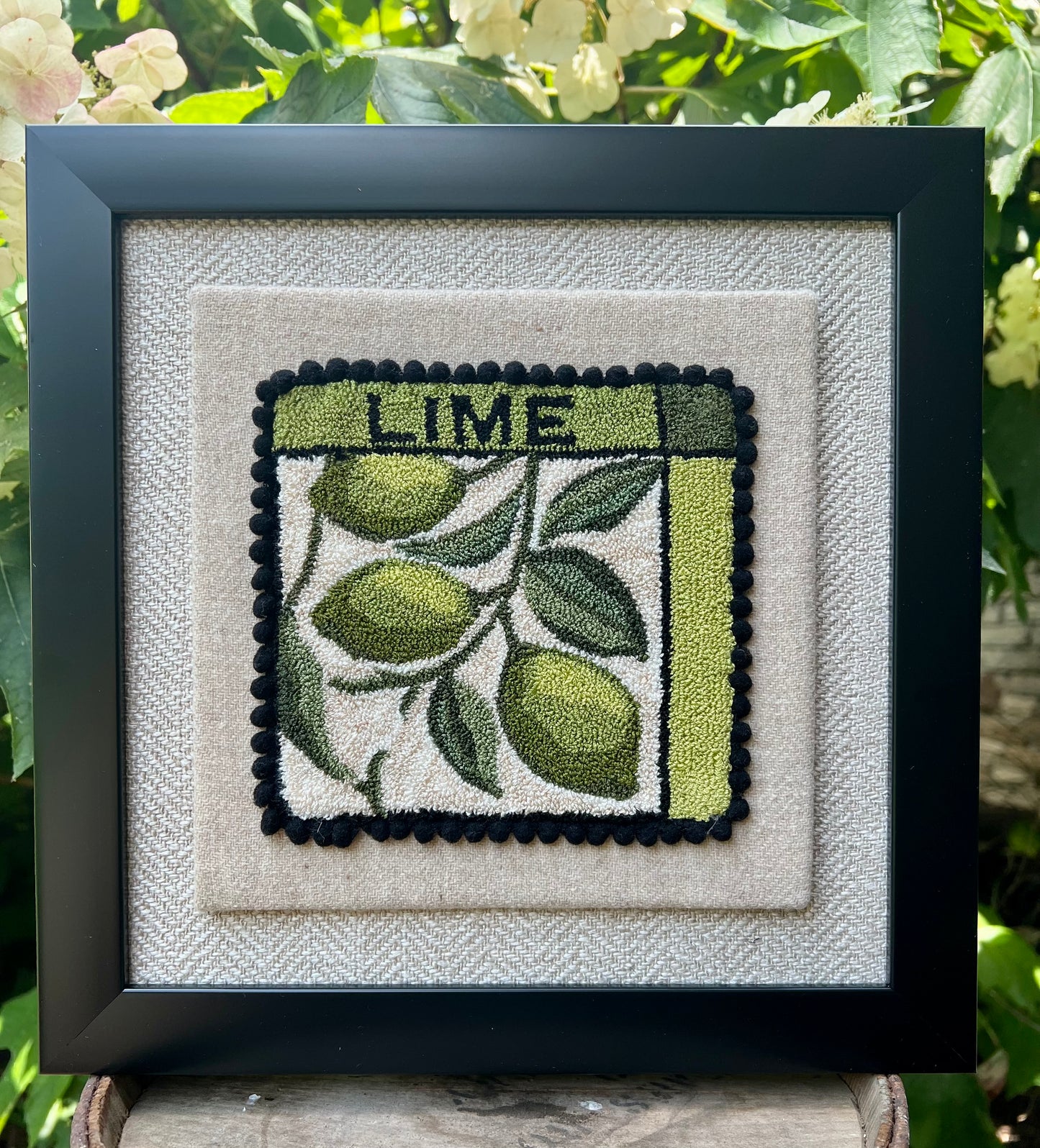 Lime Punch Needle Pattern, Paper or Printed on Cloth options, by Orphaned Wool, copyright 2025 Kelly Kanyok. Pattern features a series of three limes hanging from a vine with the word LIME at the top of the design.