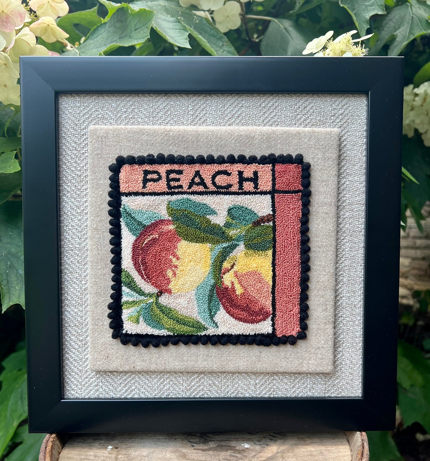 Peach PDF Punch Needle Digital Download pattern by Orphaned Wool, copyright 2025 Kelly Kanyok. This pattern features two colorful peaches along with the word PEACH.