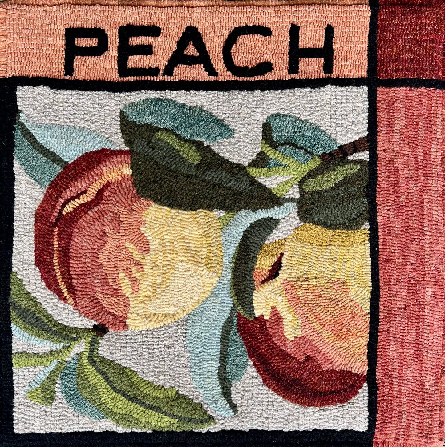 Peach -Rug Hooking pattern by Orphaned Wool, copyright © 2025 Kelly Kanyok. This pattern is part of the Fruit Themed pattern series. The design was enlarged 300% to create this wonderful pillow design. All rights reserved.