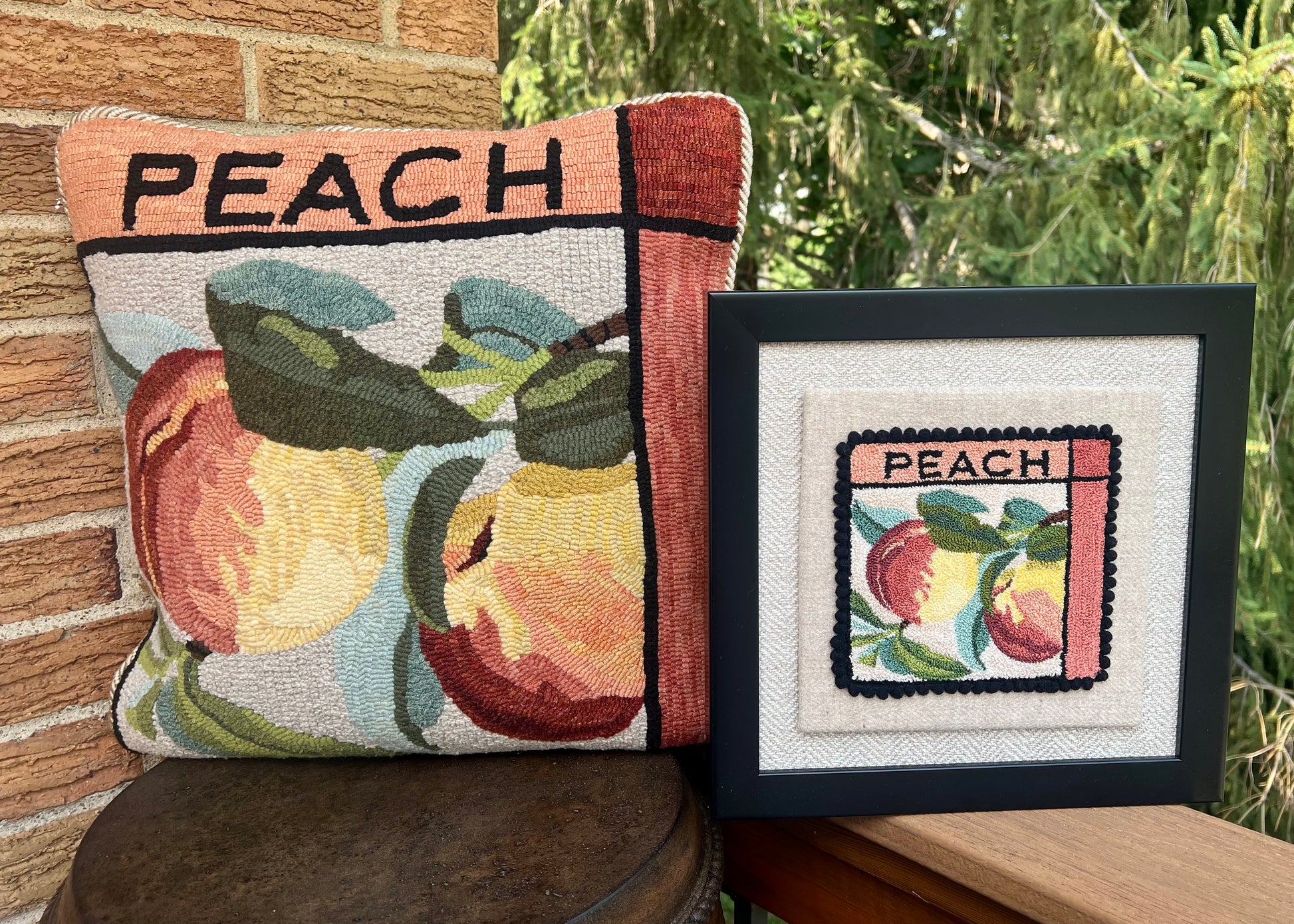 Peach paper rug hooking pattern by Orphaned Wool, copyright © 2025 Kelly Kanyok. This paper pattern is designed to be enlarged. This picture shows the finished design enlarged 300% to create a beautiful pillow. The design features two peaches with the word peach on the top. This pattern is one of four fruit patterns available. Sold individually or as a set of four. Lemon, Lime, Peach, and Cherry designs. Also available as a punch needle pattern- sold separately.