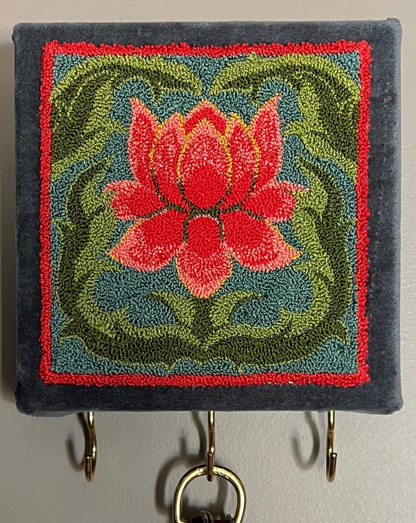 Blooming Punch Needle Pattern by Orphaned Wool. This wonderful design makes a lovely frame design or as shown as a perfect key or jewelry hanger. This design is perfect for the beginner or experienced punch needle artist. Blooming Copyright 2023 Kelly Kanyok/Orphaned Wool
