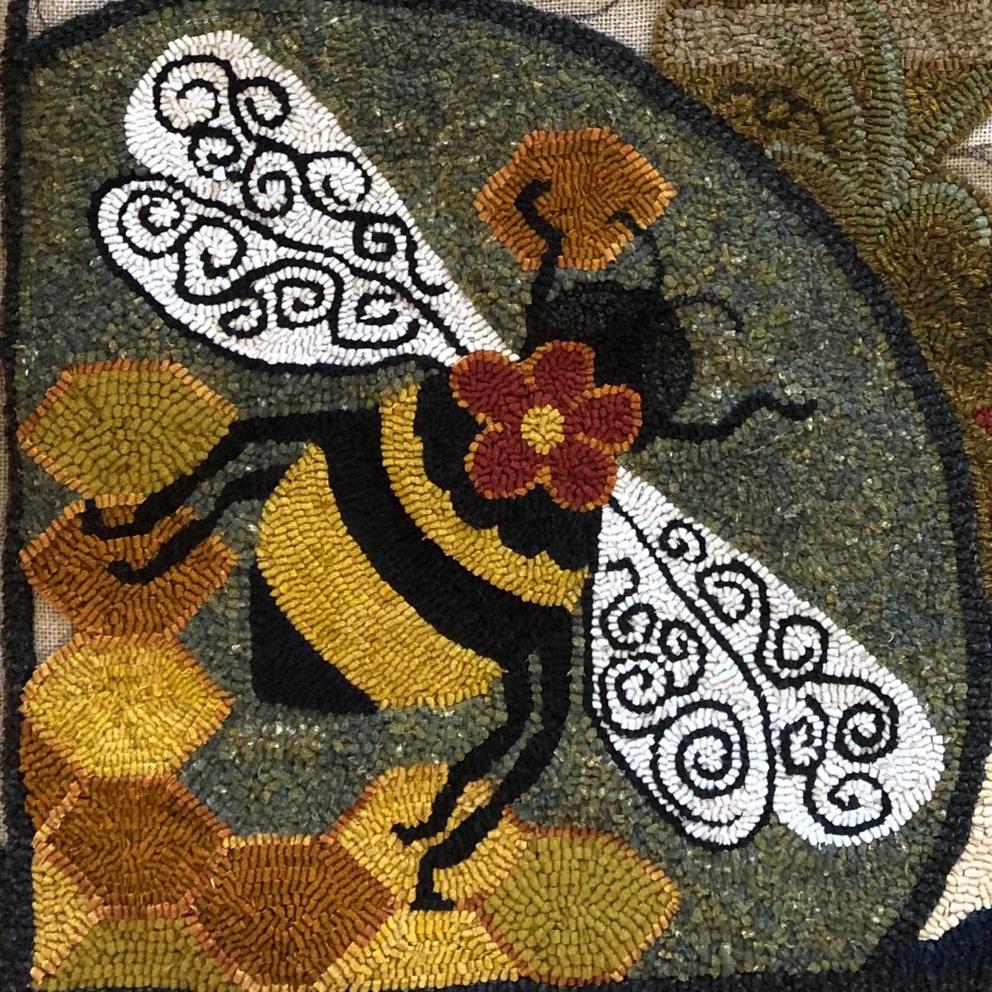 Honey Bee- Rug Hooking pattern on Linen designed by Kelly Kanyok of Orphaned Wool. This is a wonderful Bumblebee Pattern with a Bee Skep and Honeycombs background. The bee are enjoying all the flowers is this sweet design.