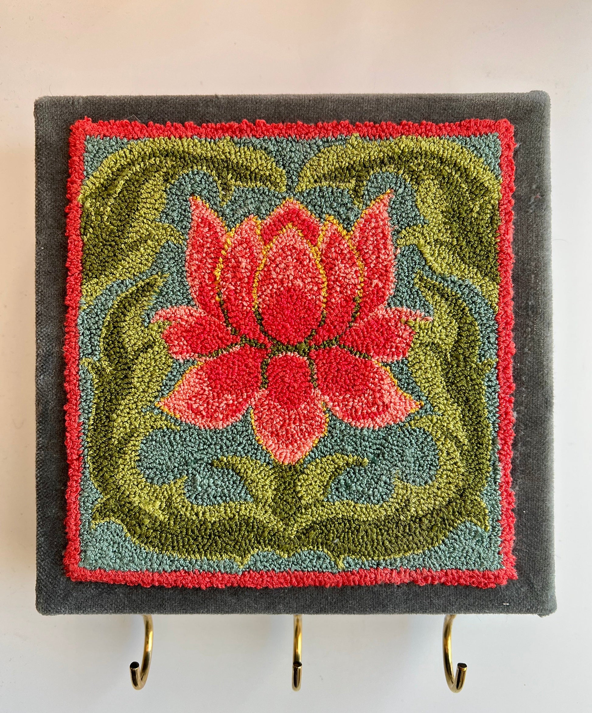 Blooming Punch Needle Pattern by Orphaned Wool. This wonderful design makes a lovely frame design or as shown as a perfect key or jewelry hanger. This design is perfect for the beginner or experienced punch needle artist. Blooming Copyright 2023 Kelly Kanyok/Orphaned Wool